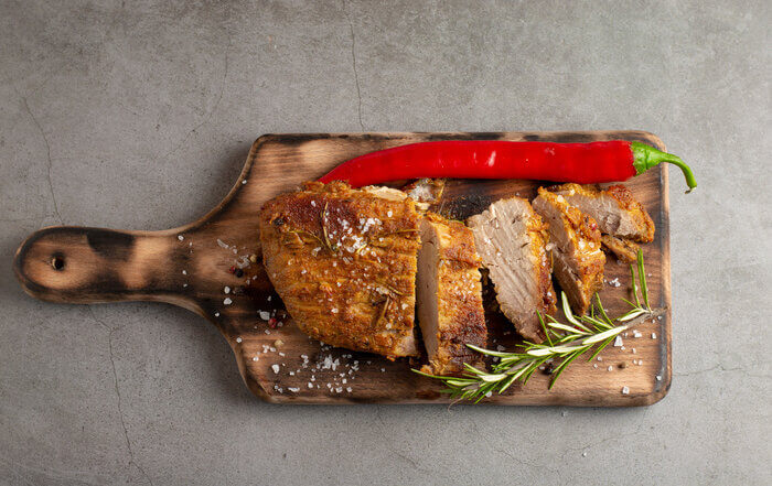 Sunday roasted pork tenderloin, juicy and succulent oven-baked piece of meat rubbed with mustard and spices: rosemary, pepper