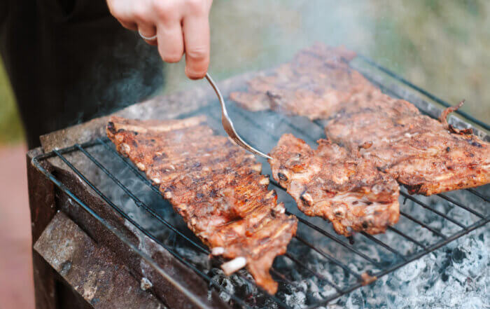 Catering expert Cooking pork ribs on the grill